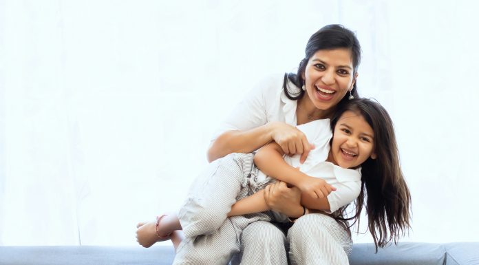 Called to be a Foster Mom vivek-kumar via unsplash a woman and child sitting on a couch laughing at the camera