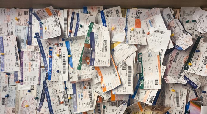 Ticket System: How To Start One in Your Home billow926 via unsplash tickets hung on a cork board