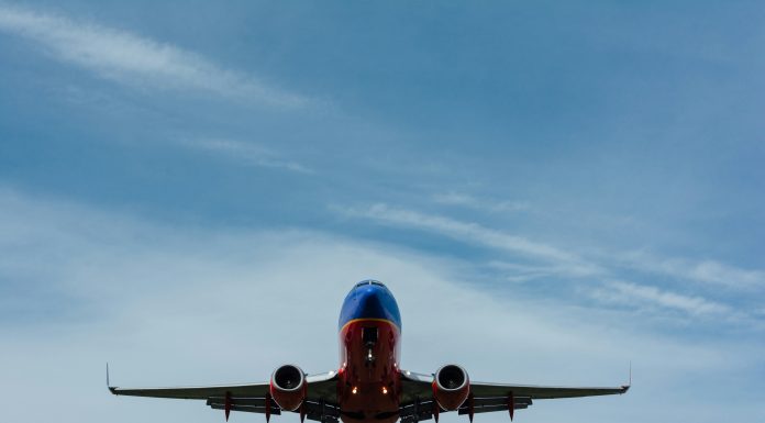 The Trip of a Lifetime gary-lopater via unsplash red and blue airplane headed for the camera with a cloudy sky behind it