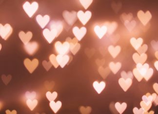 The Un-Valentine’s Day: What Does a Girl Do When She’s Got No Boo? lights that look like hearts on a pink ish brown background