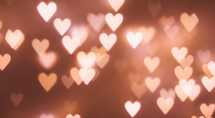The Un-Valentine’s Day: What Does a Girl Do When She’s Got No Boo? lights that look like hearts on a pink ish brown background