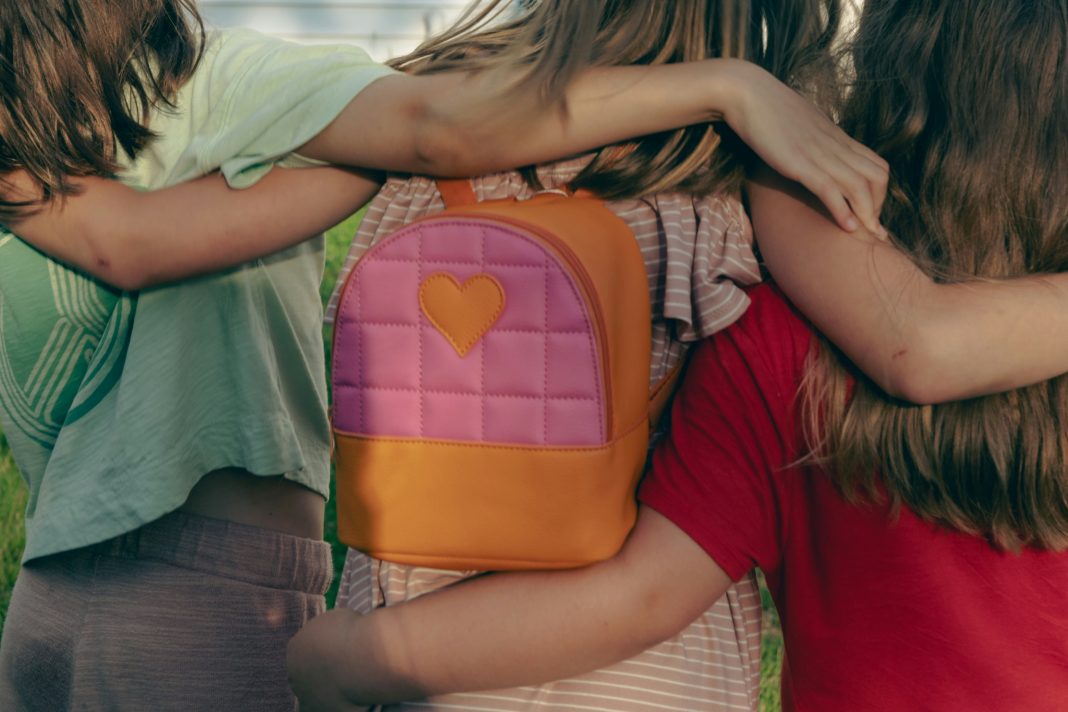 nellie-adamyan via unsplash three kids with their arms around each other