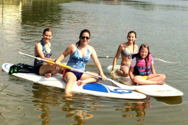 four girls paddle boarding