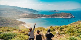 Tron Le via Unsplash three women on a rock overlooking forrest and the ocean
