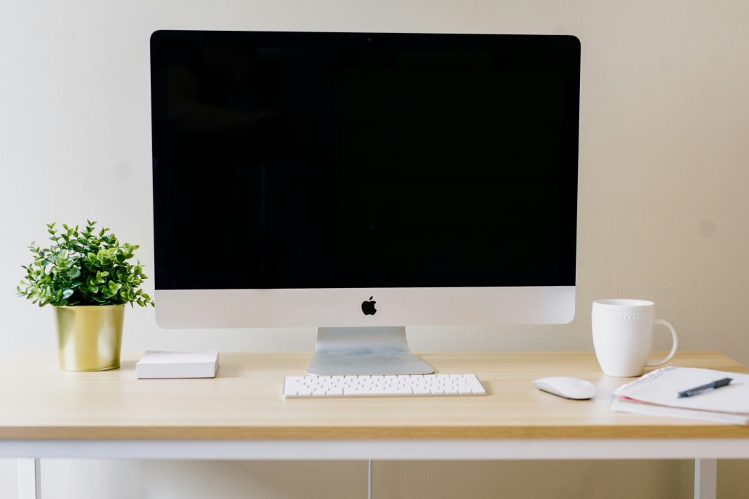 Cowardly Comments on the Internet Amy hirschi unsplash - blank computer screen with keyboard, white mug and plant