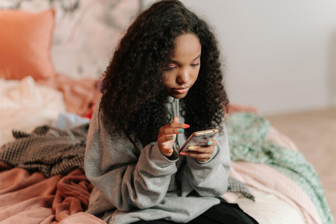 teen girl on her phone, teen slang parents should know 2025