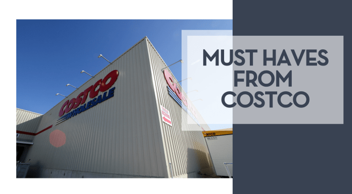 Must Haves from Costco Marcus Reubenstein via unsplash outside of CostCo Wholesale club with words 'must haves from costco' on the side over dark blue
