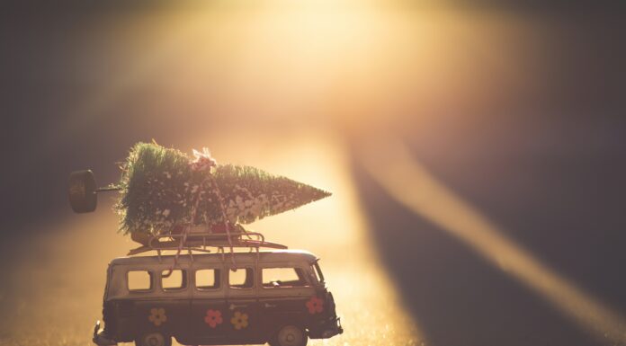 Yours, Mine and The Holiday Season Denist Johnson via Unsplash toy van with little Christmas tree on top with the sun shining behind it