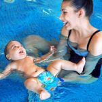 Mother and baby relaxing in the swimming pool