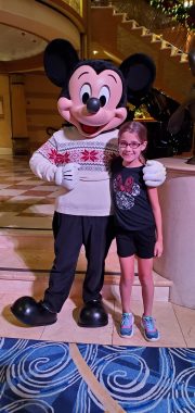 girl with Mickey Mouse in a holiday sweater