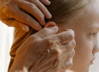 Lice Happens: From Lousy Head to Fresh Head Grandmother gently combs a young girl’s hair in a sun-lit room, attentively inspecting each strand for lice