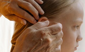 Lice Happens: From Lousy Head to Fresh Head Grandmother gently combs a young girl’s hair in a sun-lit room, attentively inspecting each strand for lice