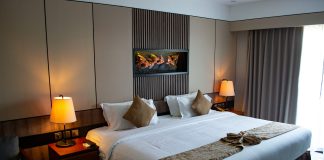 vojtech-bruzek via unsplash hotel bed with lamps on by the side