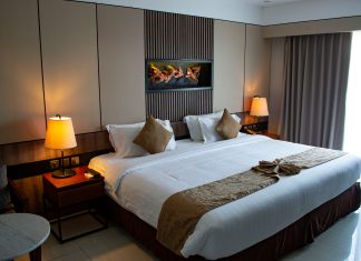 2 Cheap and Fun Orlando Staycations vojtech-bruzek via unsplash hotel bed with lamps on by the side