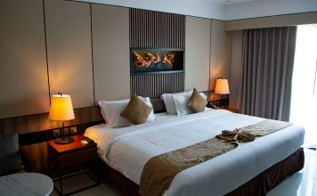 vojtech-bruzek via unsplash hotel bed with lamps on by the side