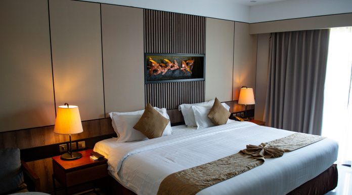 2 Cheap and Fun Orlando Staycations vojtech-bruzek via unsplash hotel bed with lamps on by the side