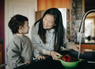 Destress Your Morning School Routine mother smiling at son washng berries for morning school routine