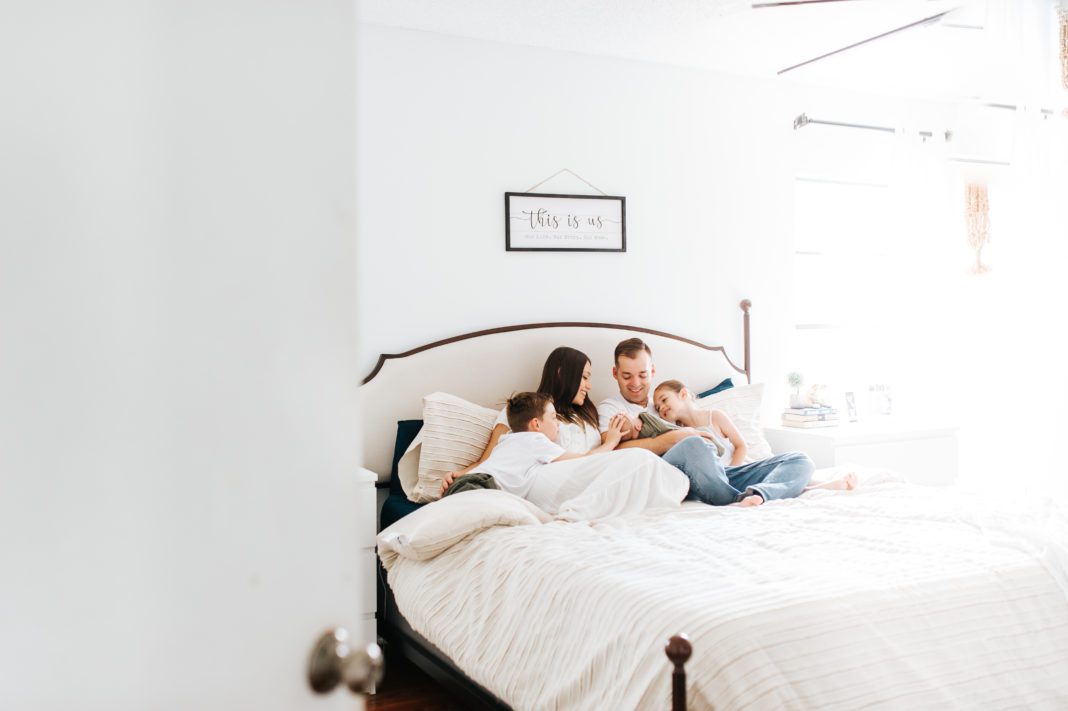 family lifestyle photography laying on bed with taupe comforter from TJMAXX