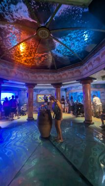 girl at the middle of a room with domed ceiling in blue and orange