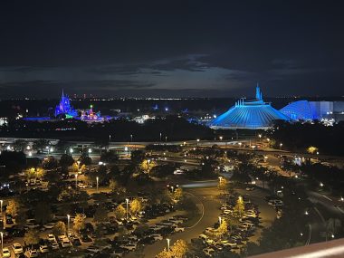 lit up cinderella castle and space mountain at night