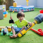 Boy with inflatable microphone at a children’s birthday party.