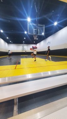 Teen playing basketball in a court