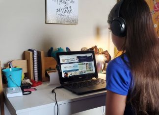 Tween girl doing virtual school on her laptop