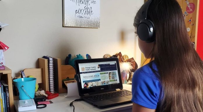 Tween girl doing virtual school on her laptop