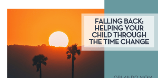 Falling Back: Helping Your Child Through The Time Change Navi via Unsplash image of a setting sun over a hill with two palm trees ahead of it with words 'Falling Back: Helping Your Child Through The Time Change' on the right