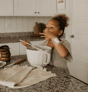 little girl in kitchen wearing Drysee bandage