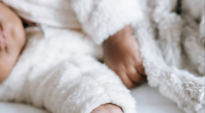 mother holding babys hand