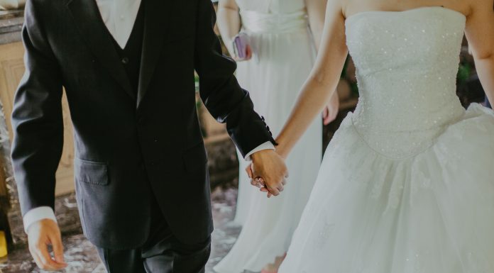 couple on wedding day holding hands