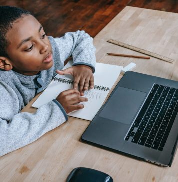 young boy looking at his computer for safety in the digital world