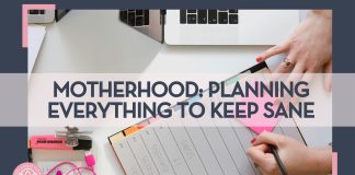 woman writing in a planner with a pen on a planner and post it note with an open computer beside her hand with words 'Motherhood: Planning Everything to Keep Sane' overtop