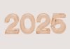 2025 in bubble numbers in rose gold on light brown background