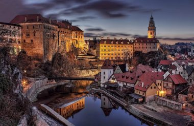 landscape image overlooking a city with old looking buildings during twilight