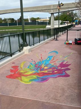 red, green, blue and purple splatter art on sidewalk