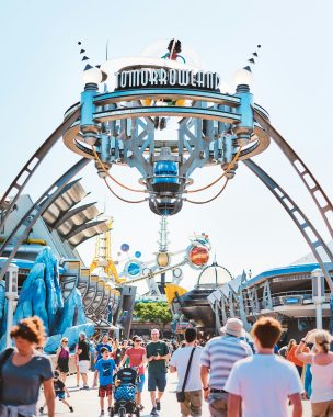 Tomorrowland sign at Magic Kingdom with a large crowd under