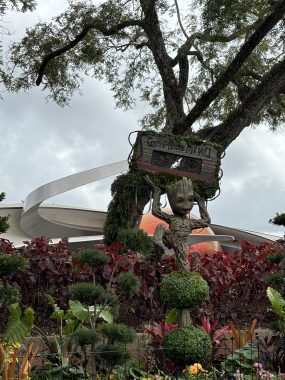 Groot, from Guardians of the Galaxy with a tape above his head and made of plants