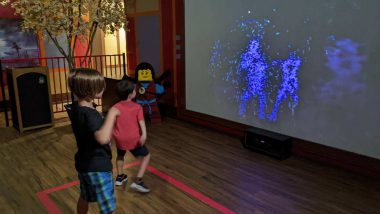 boys dancing in front of screen