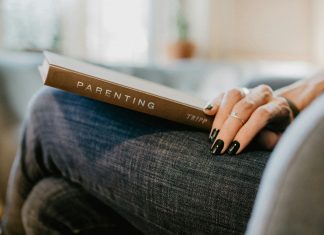 woman with parenting book on lap; breaking cycles