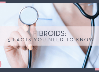 Alexandr Podvalny via unsplash phot of woman in lab coat holding up stethoscope with words 'Fibroids: 5 Facts You Need to Know'