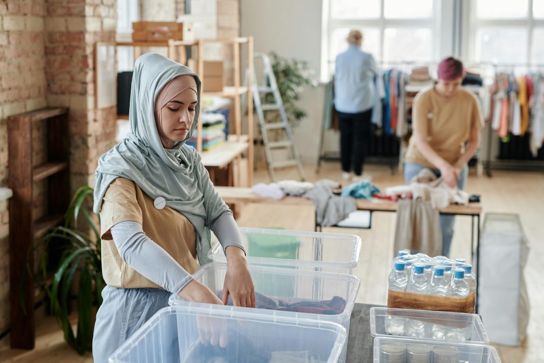 woman going through a clothing bin for eco-friendly shopping