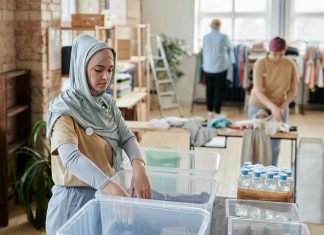 woman going through a clothing bin for eco-friendly shopping