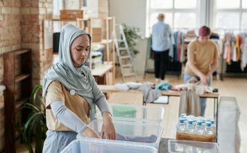 woman going through a clothing bin for eco-friendly shopping