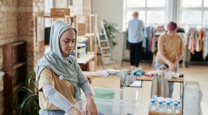 woman going through a clothing bin for eco-friendly shopping