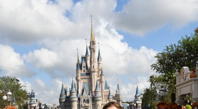 two women smiling at camera in front of Cinderella's castle in Disney World Orlando. On a girls trip