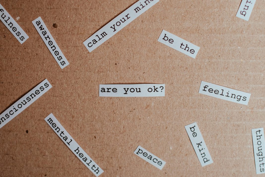 a bunch of papers saying things like mental health, peace, are you ok, be kind mental health support