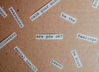 a bunch of papers saying things like mental health, peace, are you ok, be kind mental health support