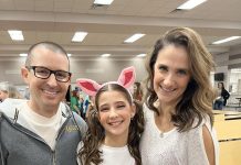 a mom, dad, and daughter staring at the camera smiling.